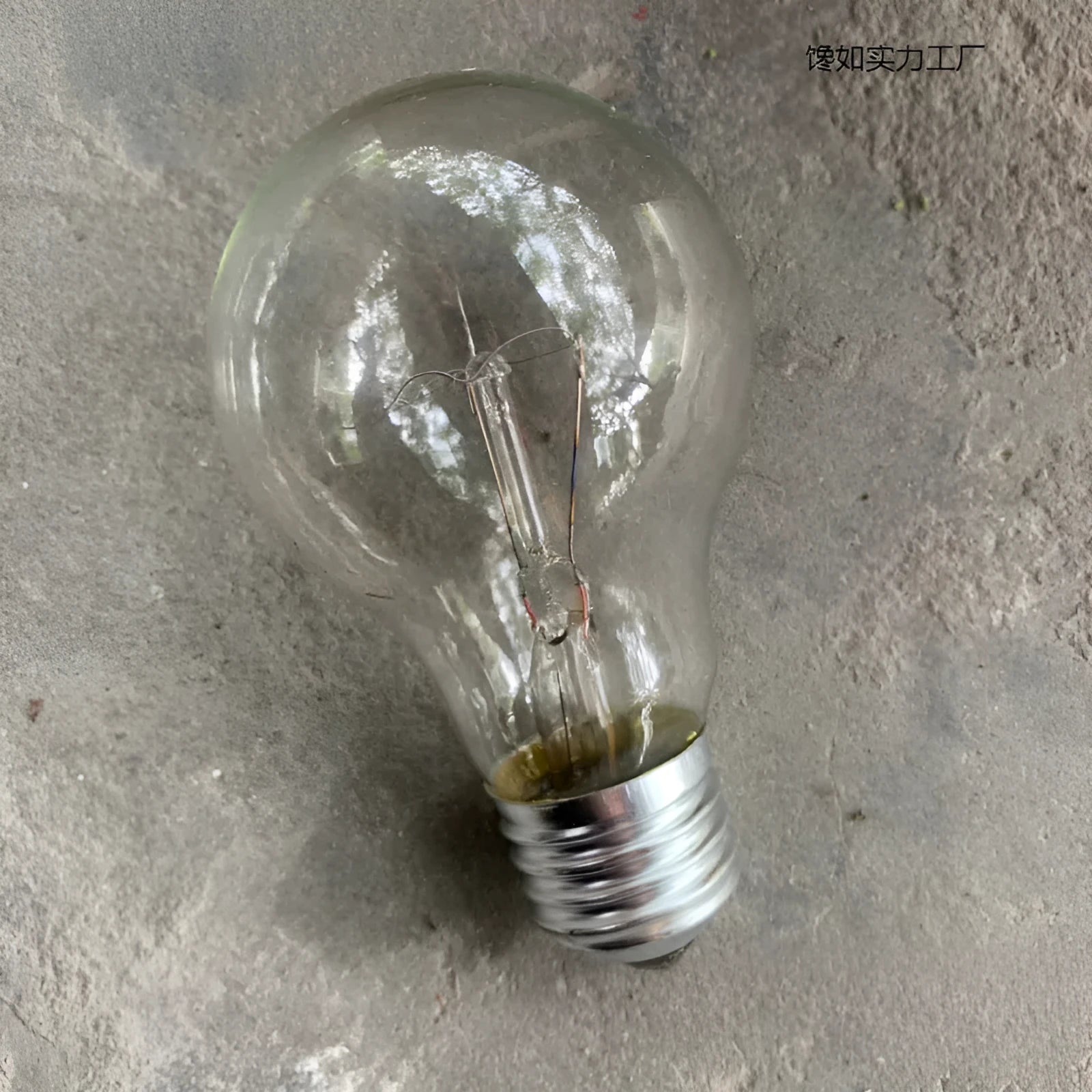 Old-fashioned incandescent tungsten bulb with E27 screw base, 220V, clear glass