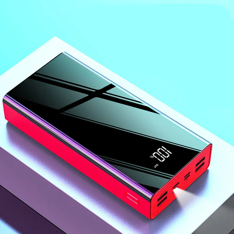 Large black 40000mAh power bank with LCD display showing battery percentage, placed next to a charging cable.