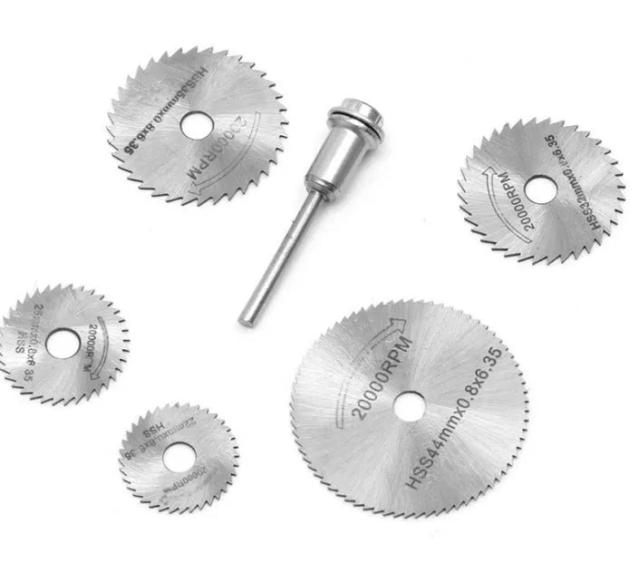 Set of six circular metal saw blades with a central mandrel hole on a white background