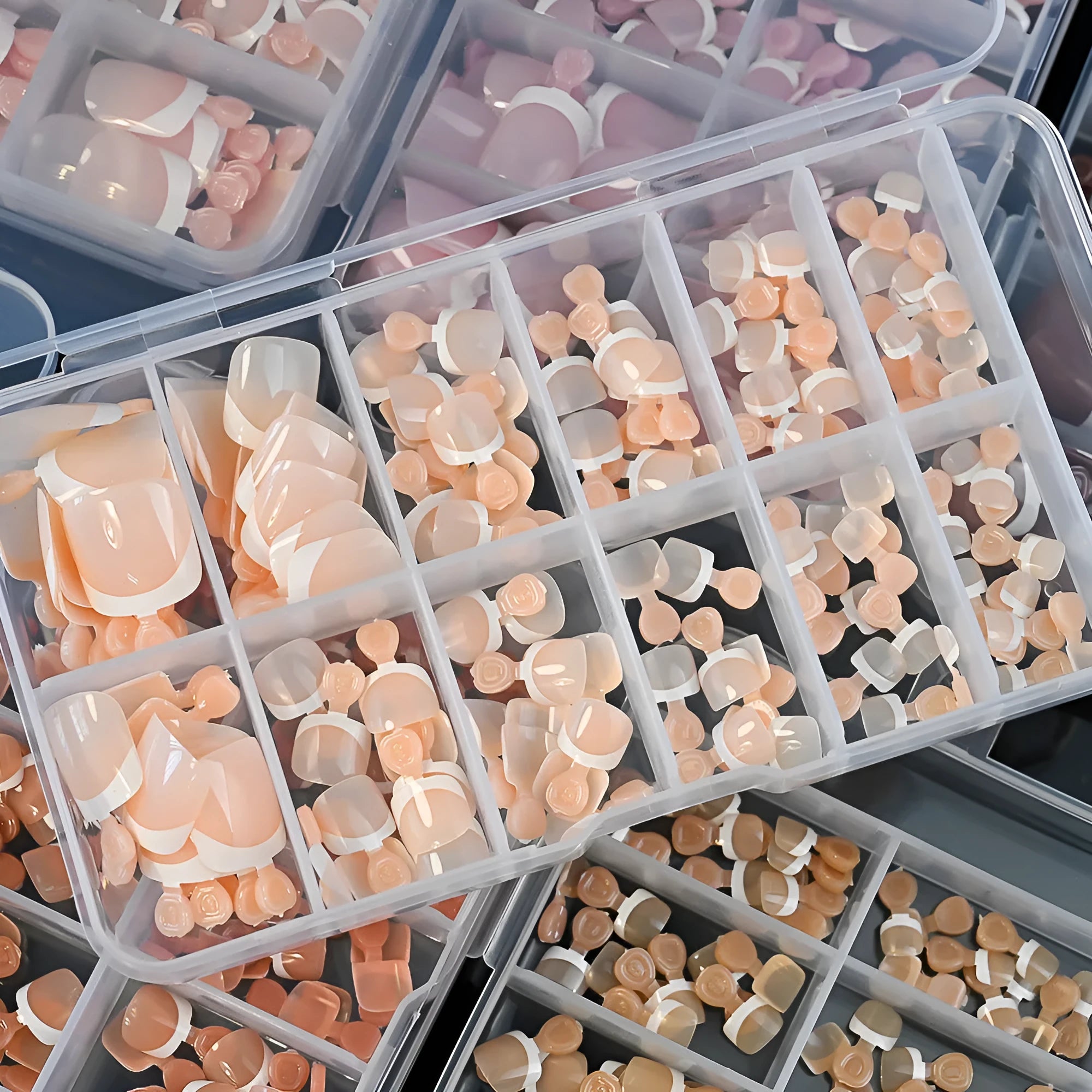 Open box showing 120 French white edge nude square false toe nail pieces in various shades.
