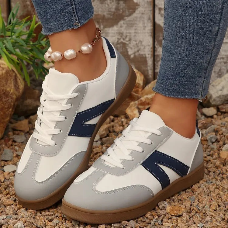 Blue women's low-top training shoes with rubber sole and front lace-up closure