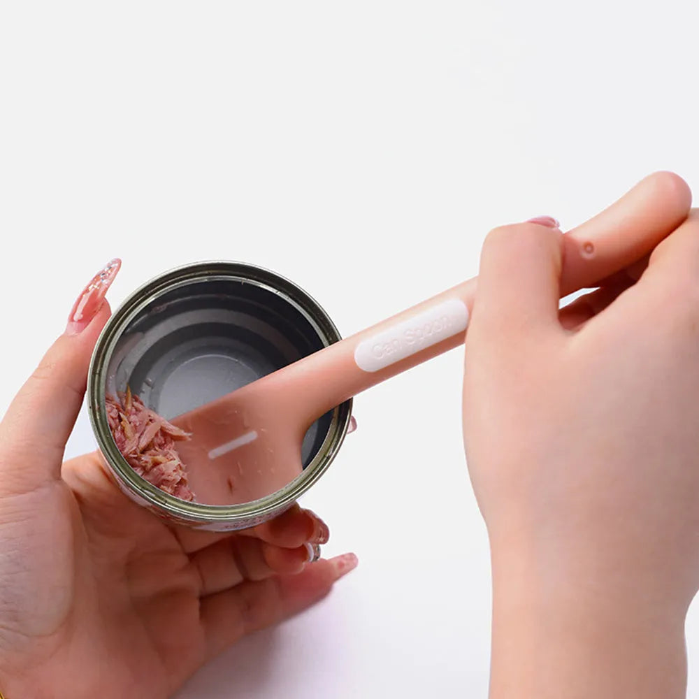 Green long-handled TPR spoon for scooping wet pet food from a tin.