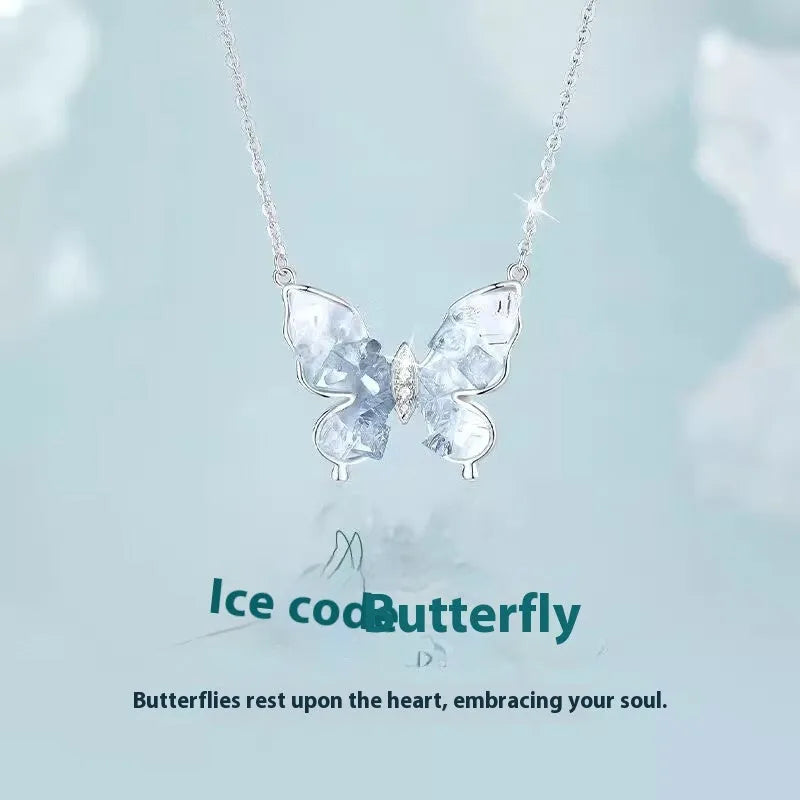 Close-up of a silver Bingyu butterfly pendant necklace on an O-ring chain.