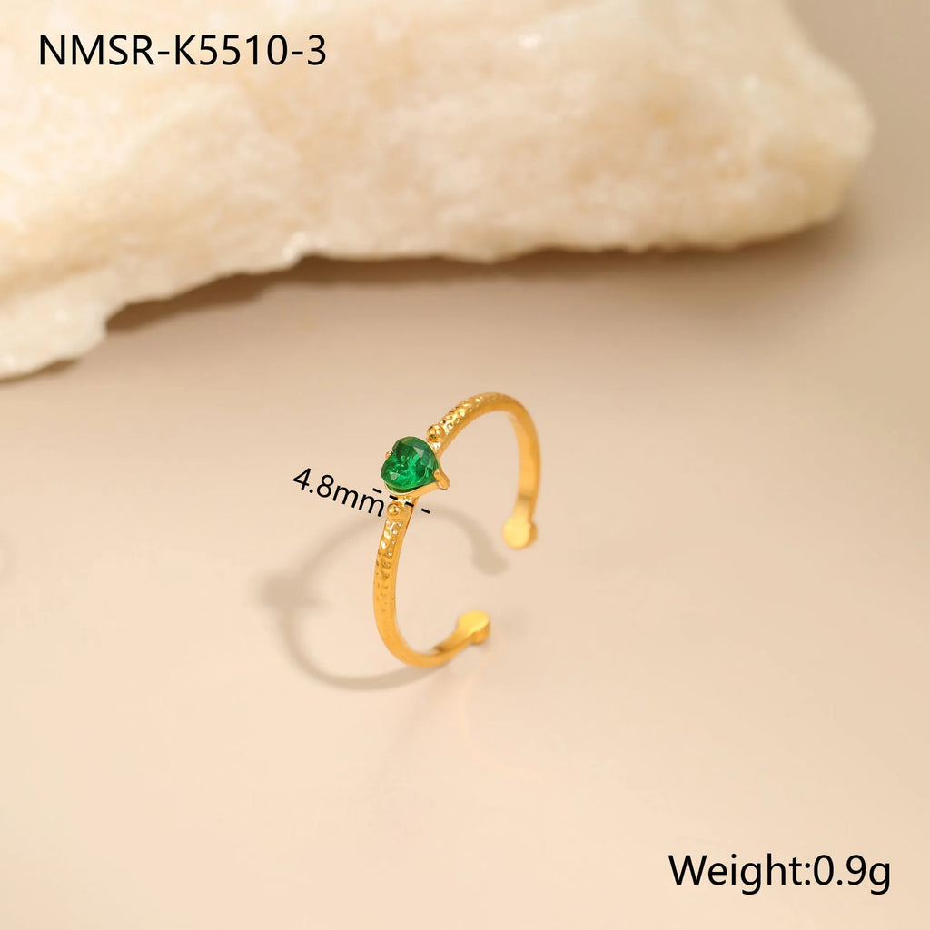 Geometric open-ended heart-shaped stainless steel ring with inlaid zircon detail in white, pink, or green.