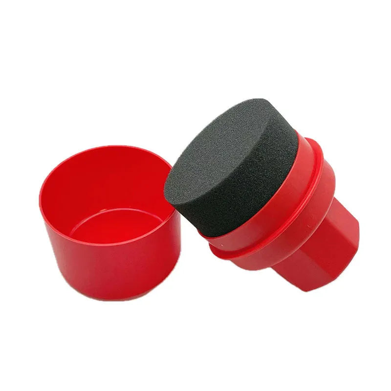 Black car tyre polishing sponge brush with a red lid, showing its size next to a car tyre.