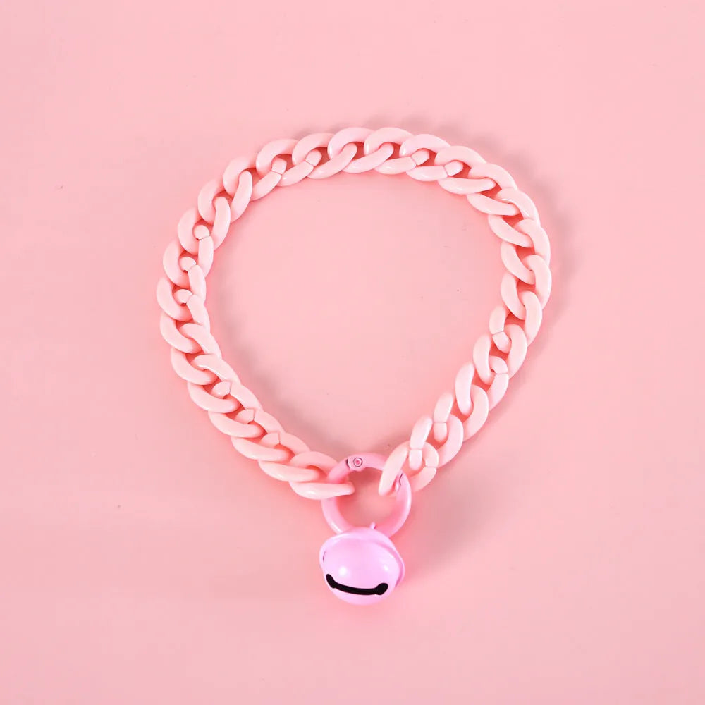 Adjustable plastic pet collar in macaron candy colours with chain detailing, shown with a buckle.