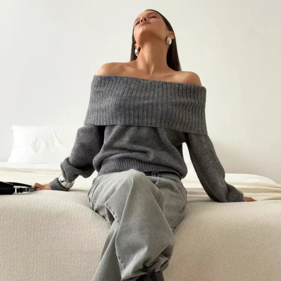Grey off-the-shoulder sweater with a 3D pattern, shown on a model.