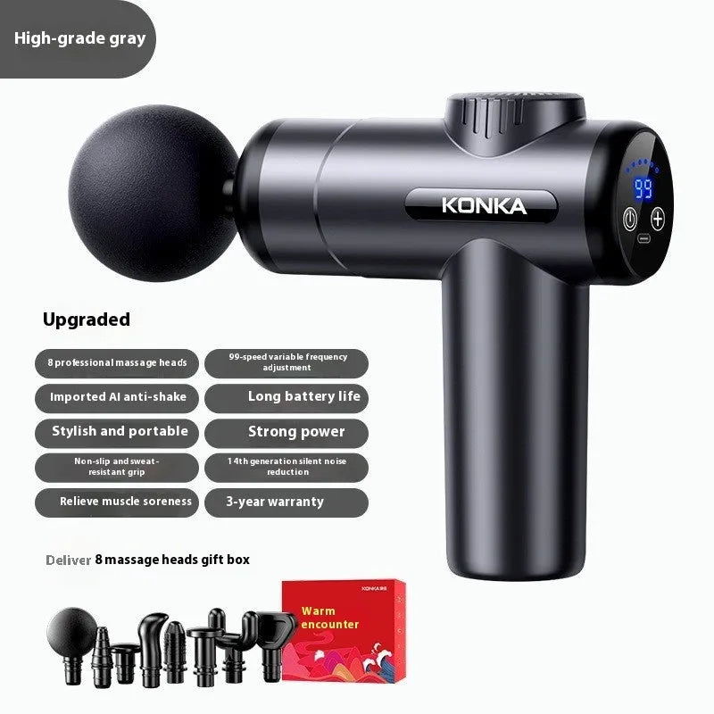 Konka V19 grey massage gun with multiple silicone attachment heads on a table.