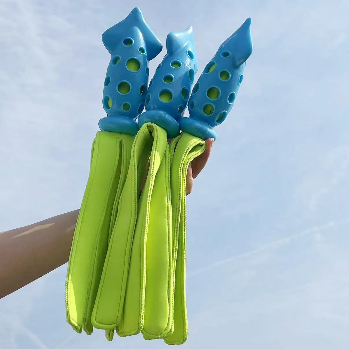 Blue cuttlefish-shaped dog chew toy with textured surface and squeaker for teeth cleaning
