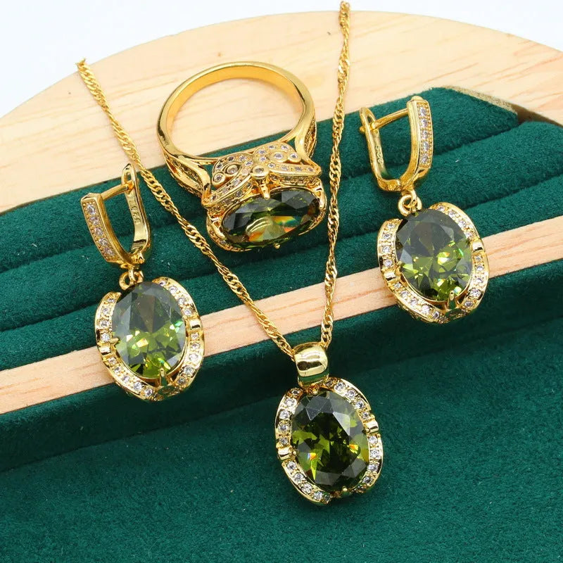 Olive green women's rhinestone jewellery suit with snake bones chain necklace, earrings, and ring on copper.