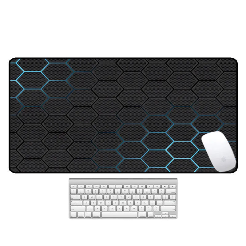 Large printed desk mouse pad with natural rubber non-slip base, shown on a wooden desk.