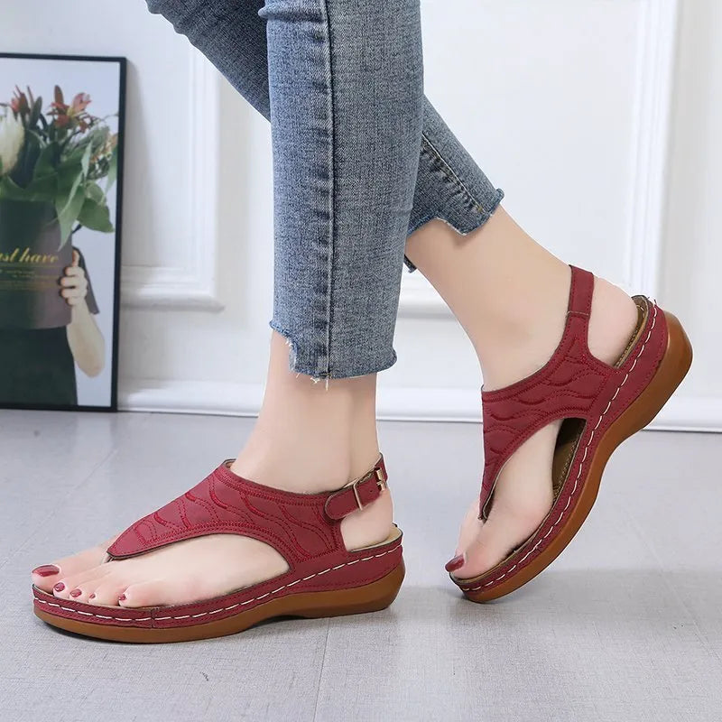 Women's black casual wedge heel flip flop sandals with an adjustable buckle strap.