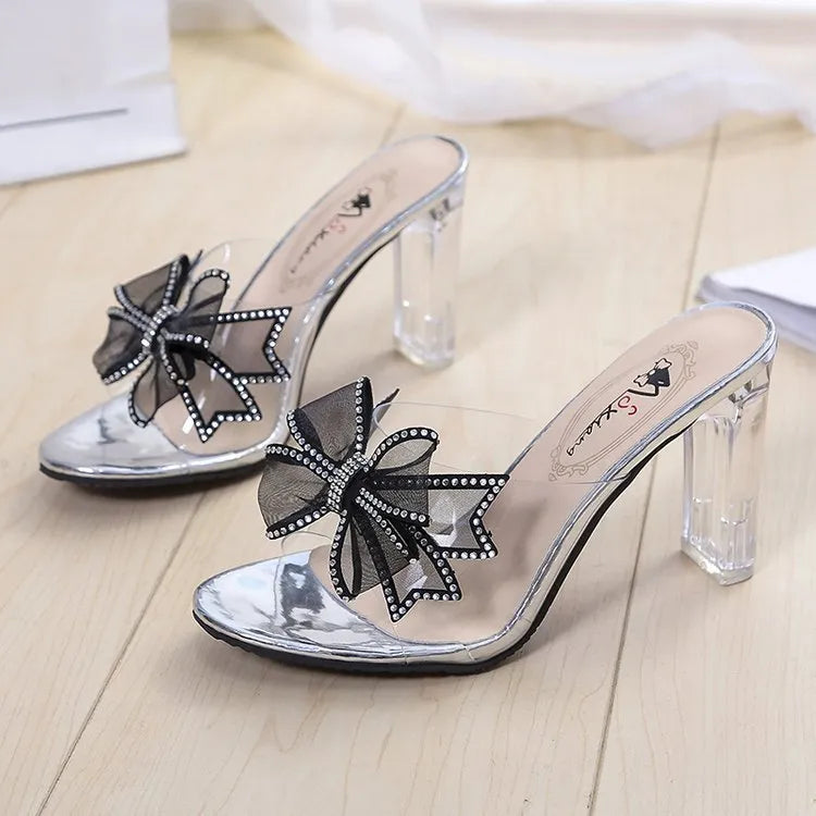 Women's transparent PVC chunky heel slippers in beige, side view showing heel and open toe