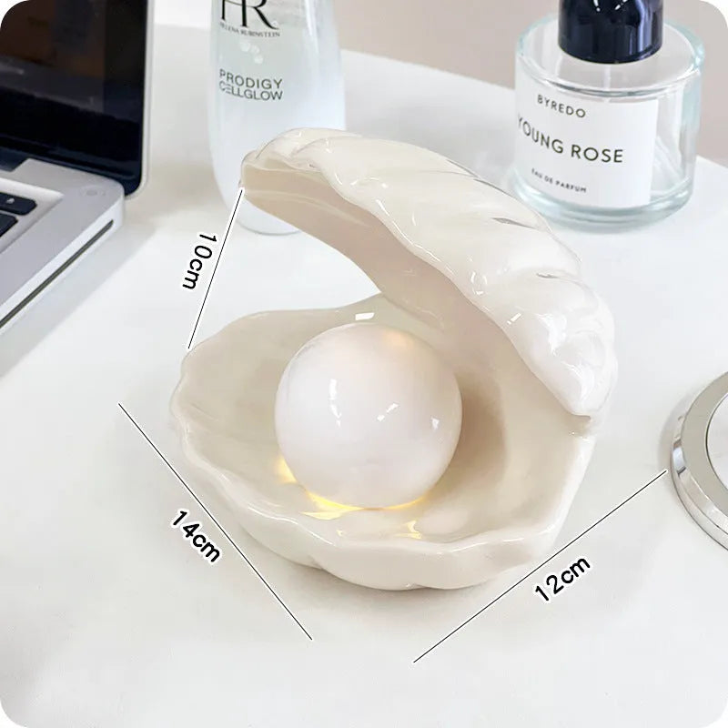 White porcelain storage tray with optional small night light, shown in pink and white shell colours on a wooden surface.
