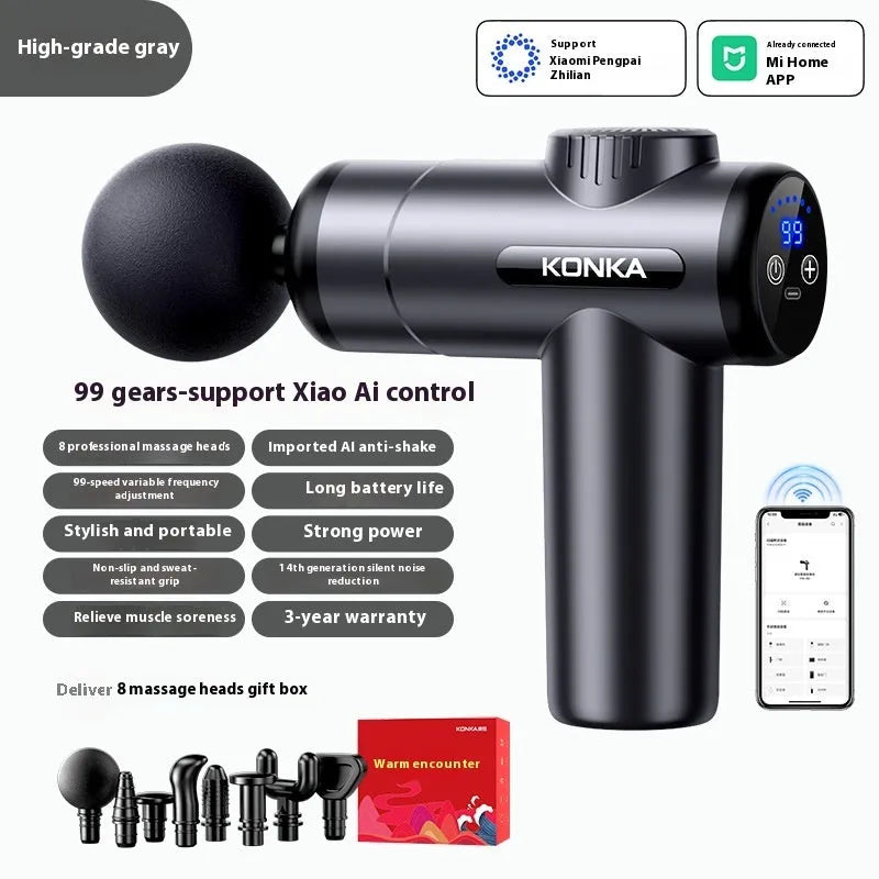 Konka V19 grey massage gun with multiple silicone attachment heads on a table.