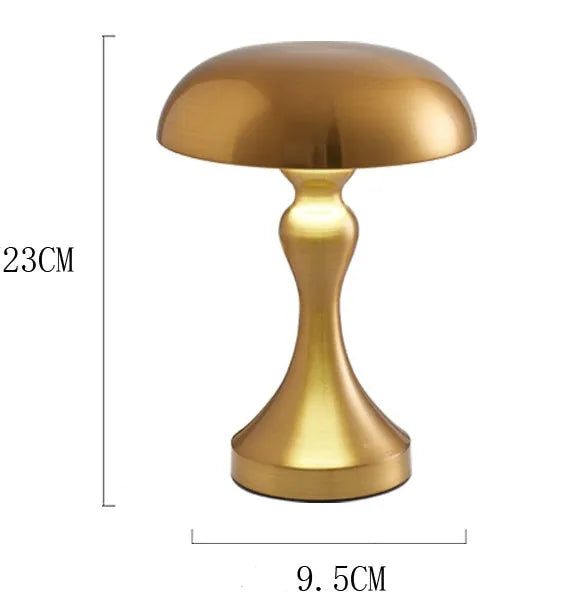 Metallic bronze touch-control LED desk lamp showing tri-colour light settings on a wooden desk.