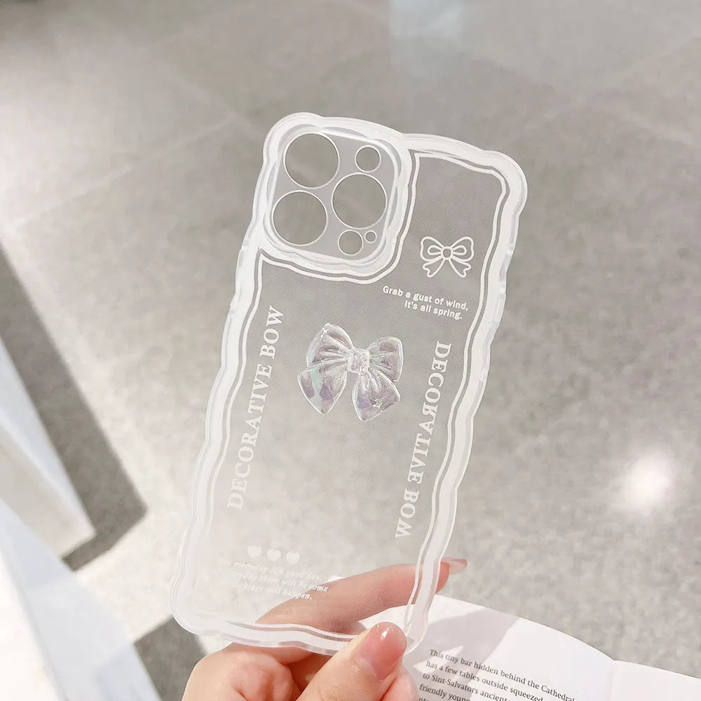 Clear iPhone case with a raised 3D ice bow design and a white love lanyard attached.