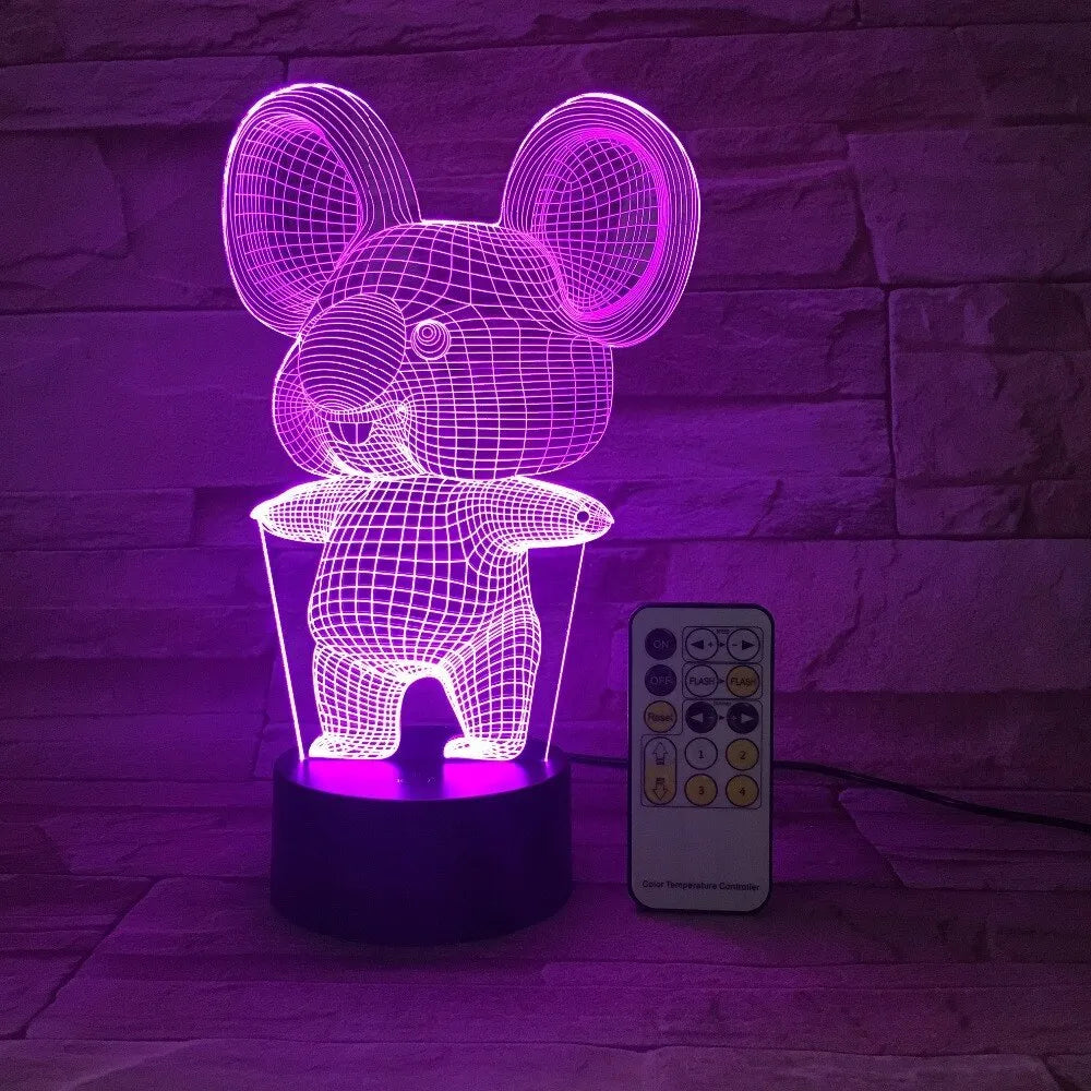 Black koala-shaped LED night light with remote control on a table.