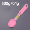 Black electronic digital scale with integrated measuring spoon showing weight display.