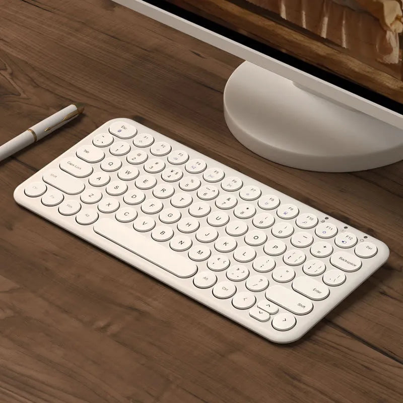 Mute white ultra-thin wireless keyboard and mouse with tiny USB receiver on a wooden desk