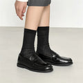 Black men's classic slip-on derby leather shoes with a rubber sole on a white background