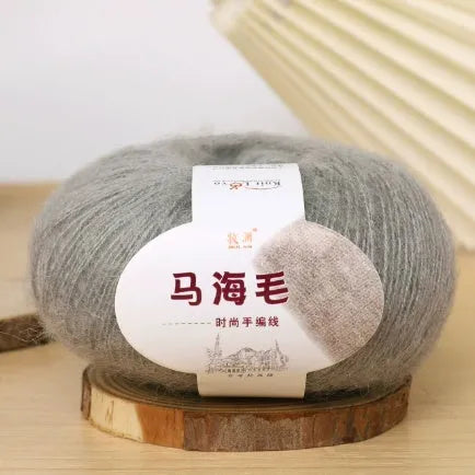 Ball of mohair yarn for DIY scarf knitting in one of 34 colours, including white, pink, blue, and green.