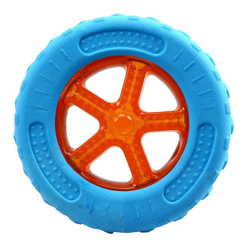 Set of three TPR dog toys: a red ball, a blue barbell, and an orange tire, floating in water.