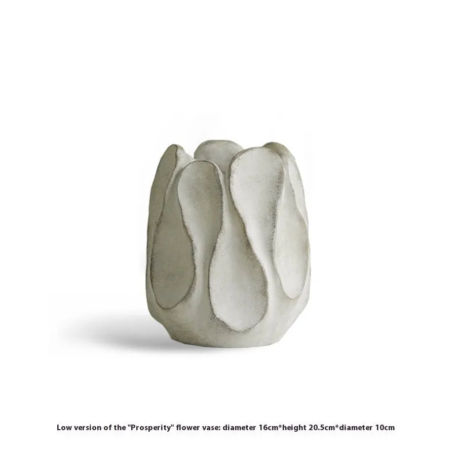 Irregular shaped ceramic art vase for flower arrangements on a desktop.