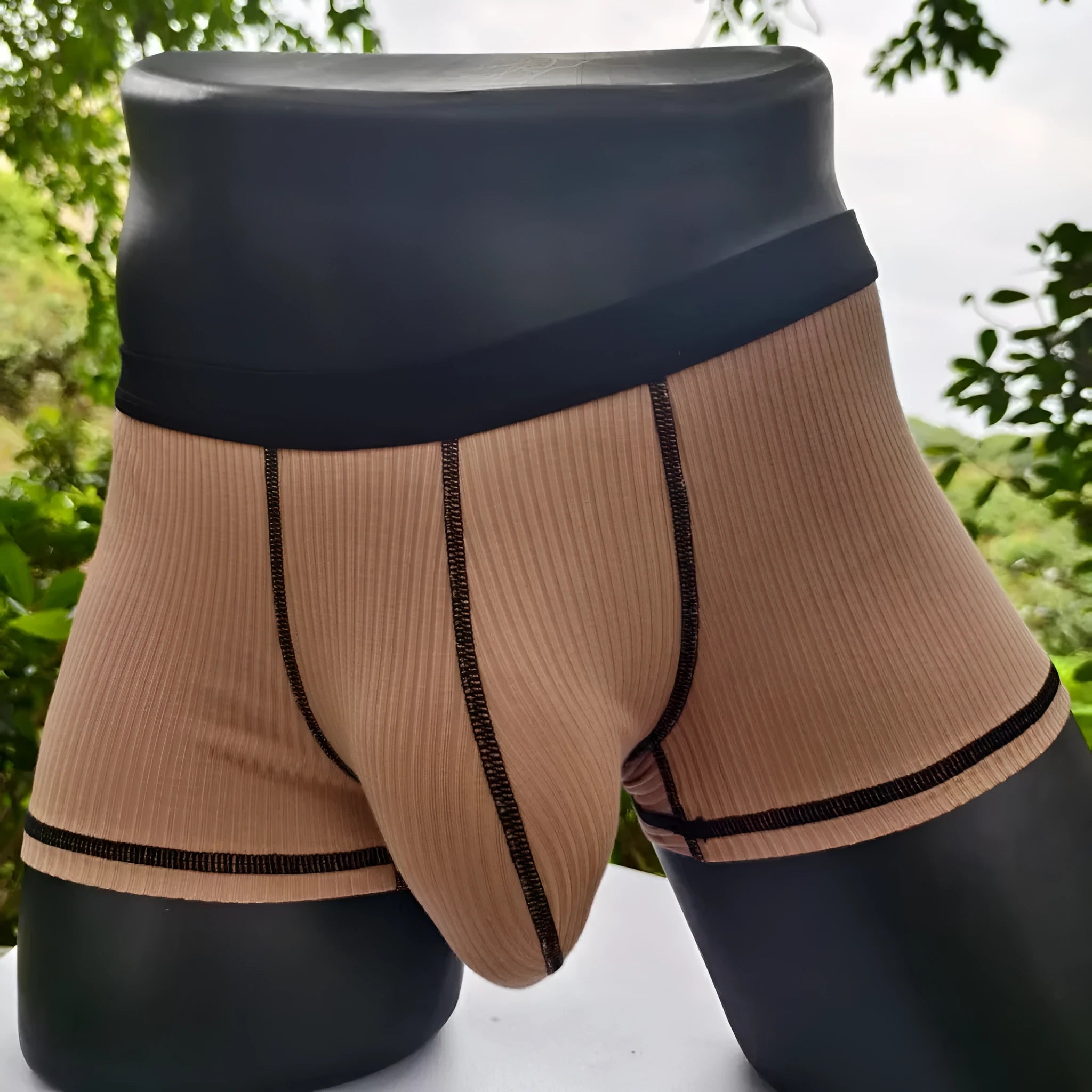 Men's solid colour breathable boxer shorts on a white background showing hip lifting design.