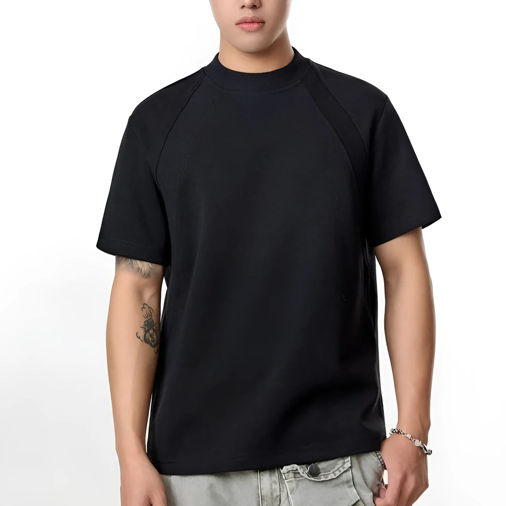 Men's loose fit short sleeve top in black with air layer stitching detail on a grey background.