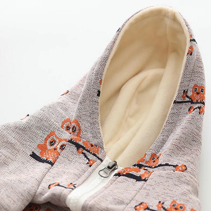 Blue cotton dog sweater with a front zip and animal print, shown on a model dog.