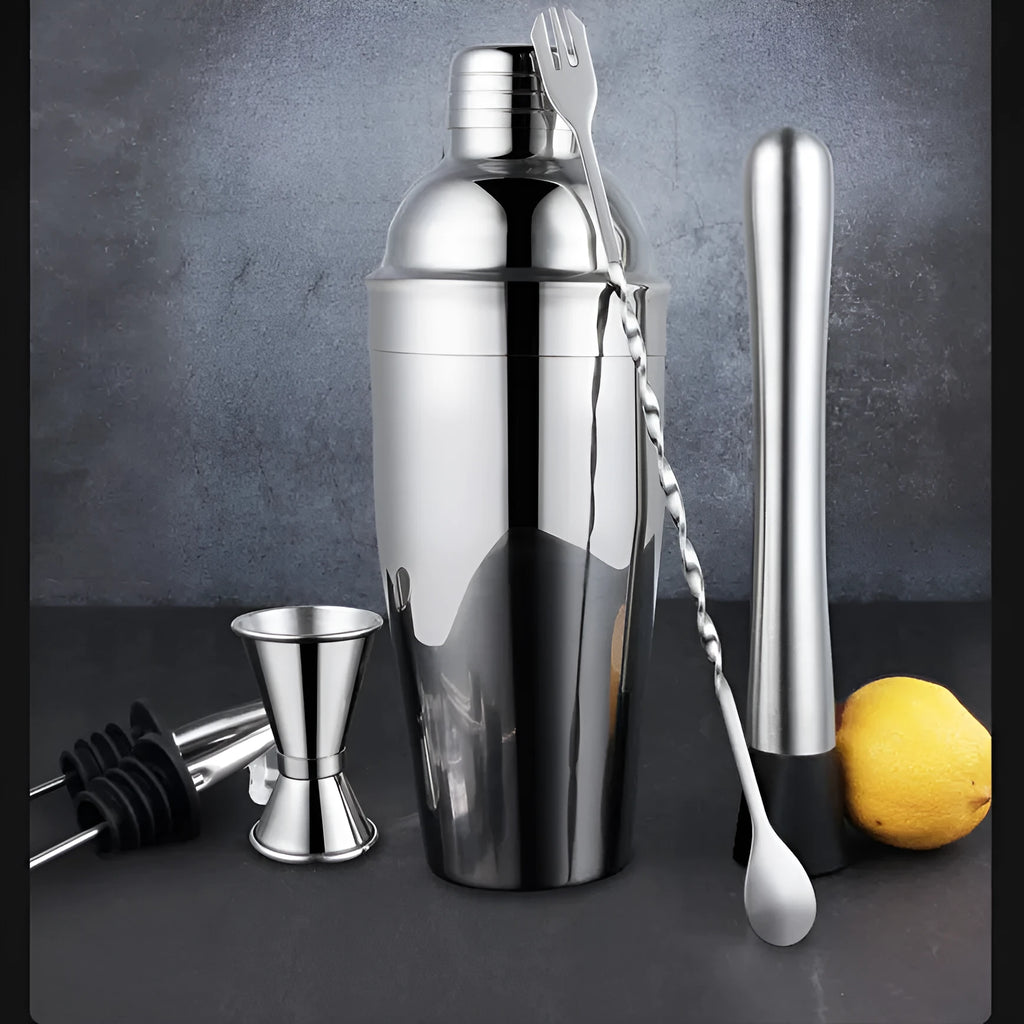 23-piece stainless steel and acrylic cocktail set with shakers, jiggers, and bar tools on a counter.