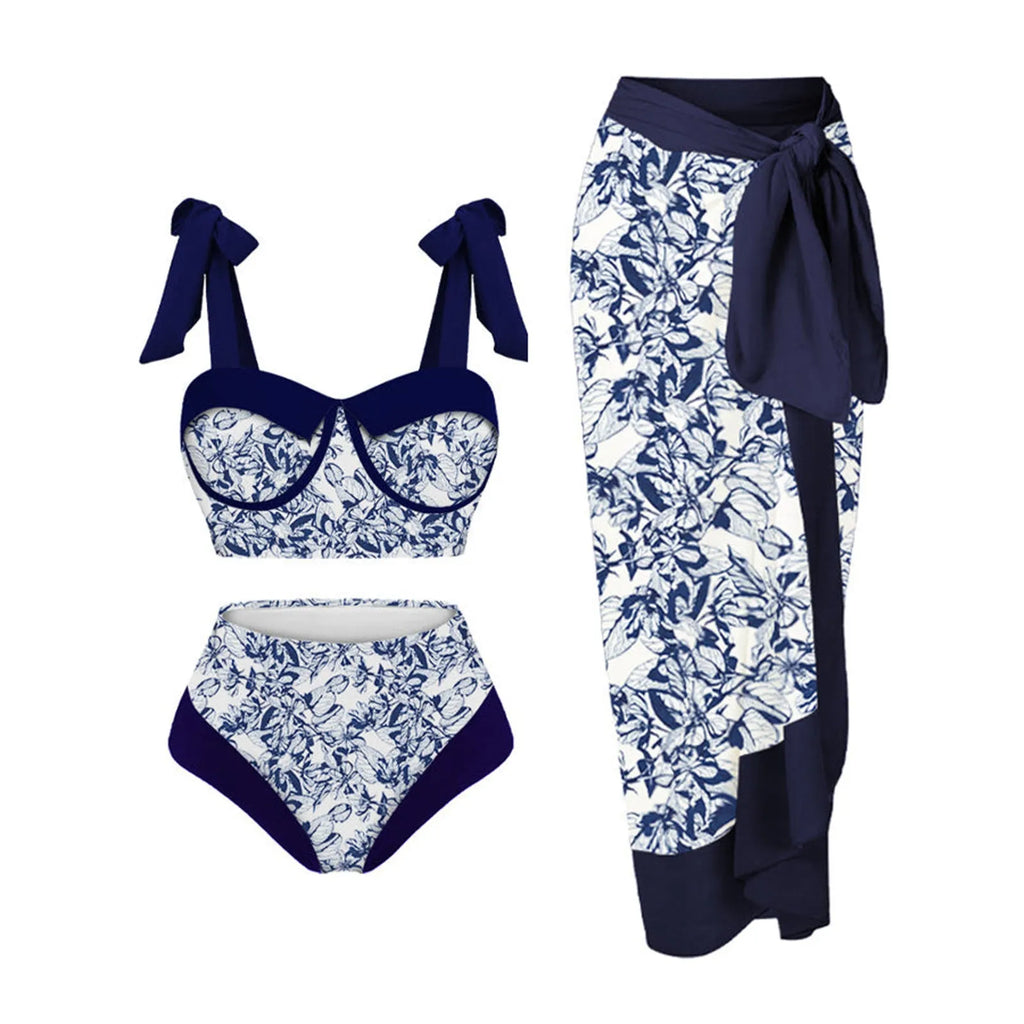 Women's pink floral print three-piece swimsuit set with skirt on a mannequin.