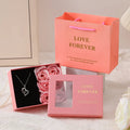 Red Korean-style gift box open to show six sculpted soap roses, with a matching handbag beside it.