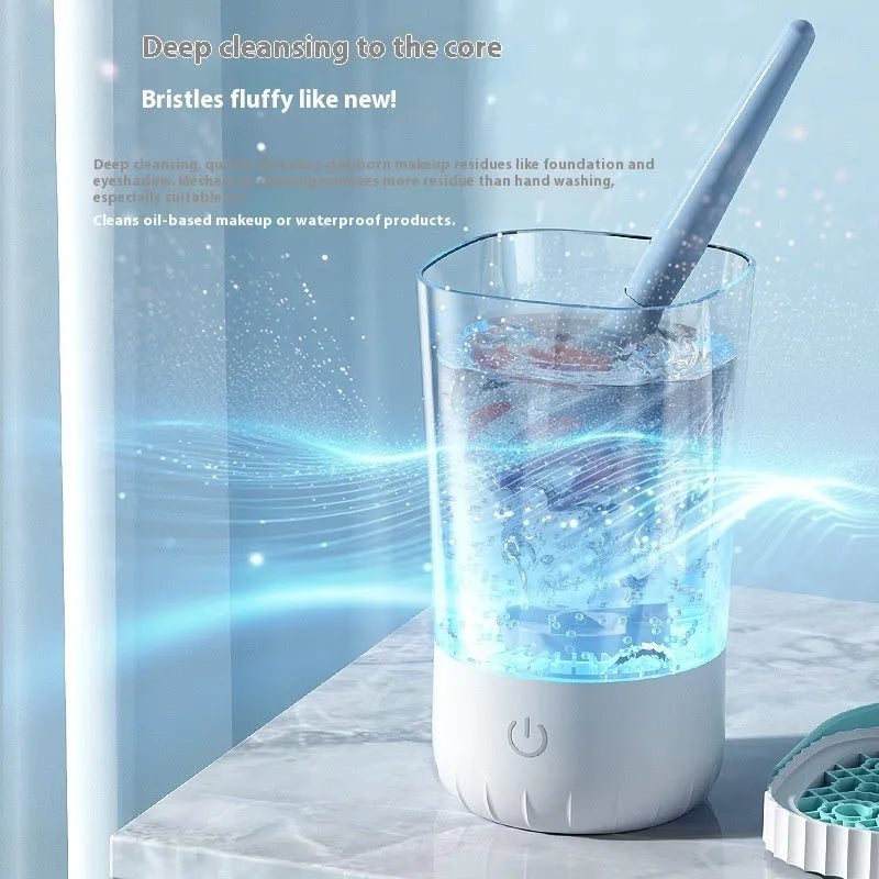 White rechargeable electric makeup brush cleaning tool with data cable.