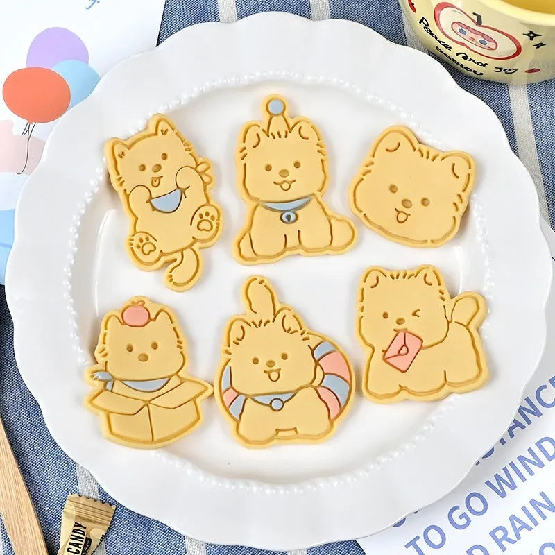 Three-dimensional plastic biscuit mould set with puppy cartoon designs including birthday hats and swimming rings