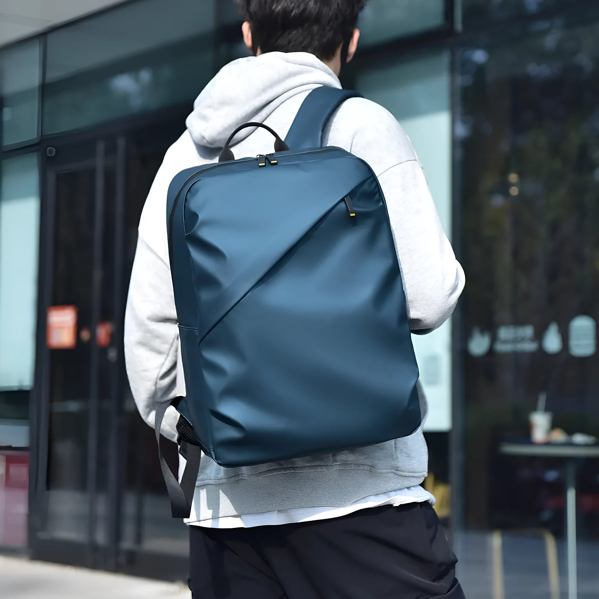 Large black waterproof backpack made from PU leather with sewing thread detailing