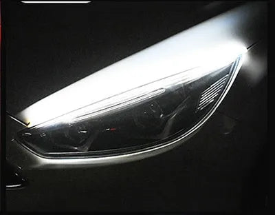 Flexible silicone car LED light strip for daytime running and flowing turn signals, showing wire connections.