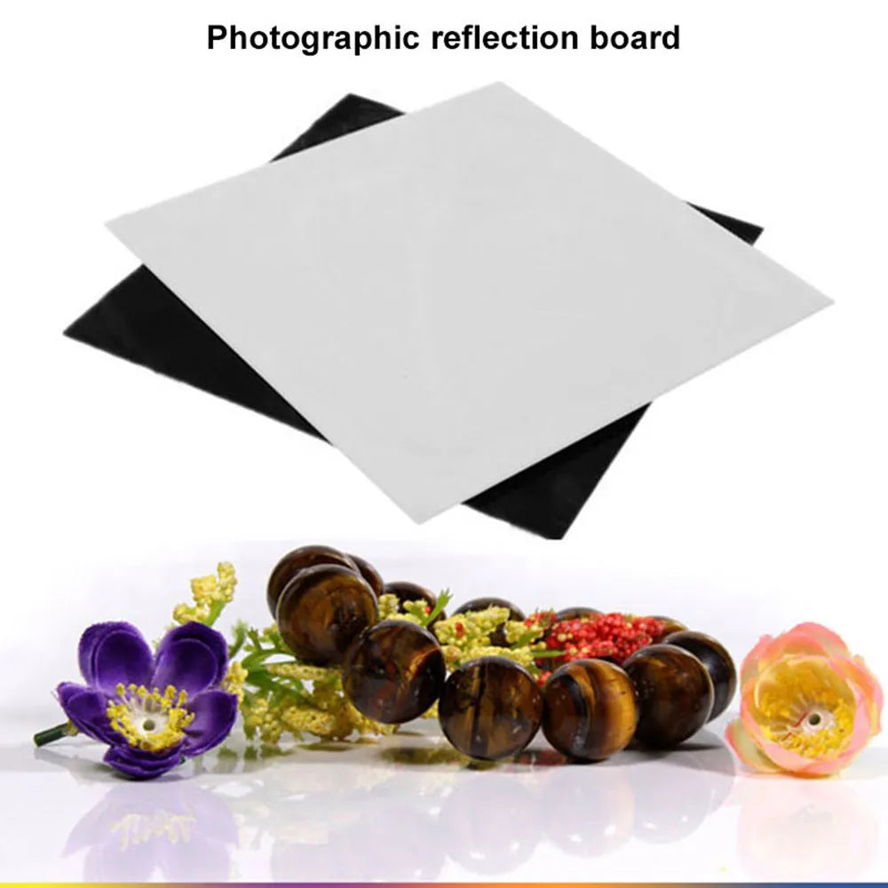 Square black and white acrylic shooting reflection boards for photography in three sizes on a table.