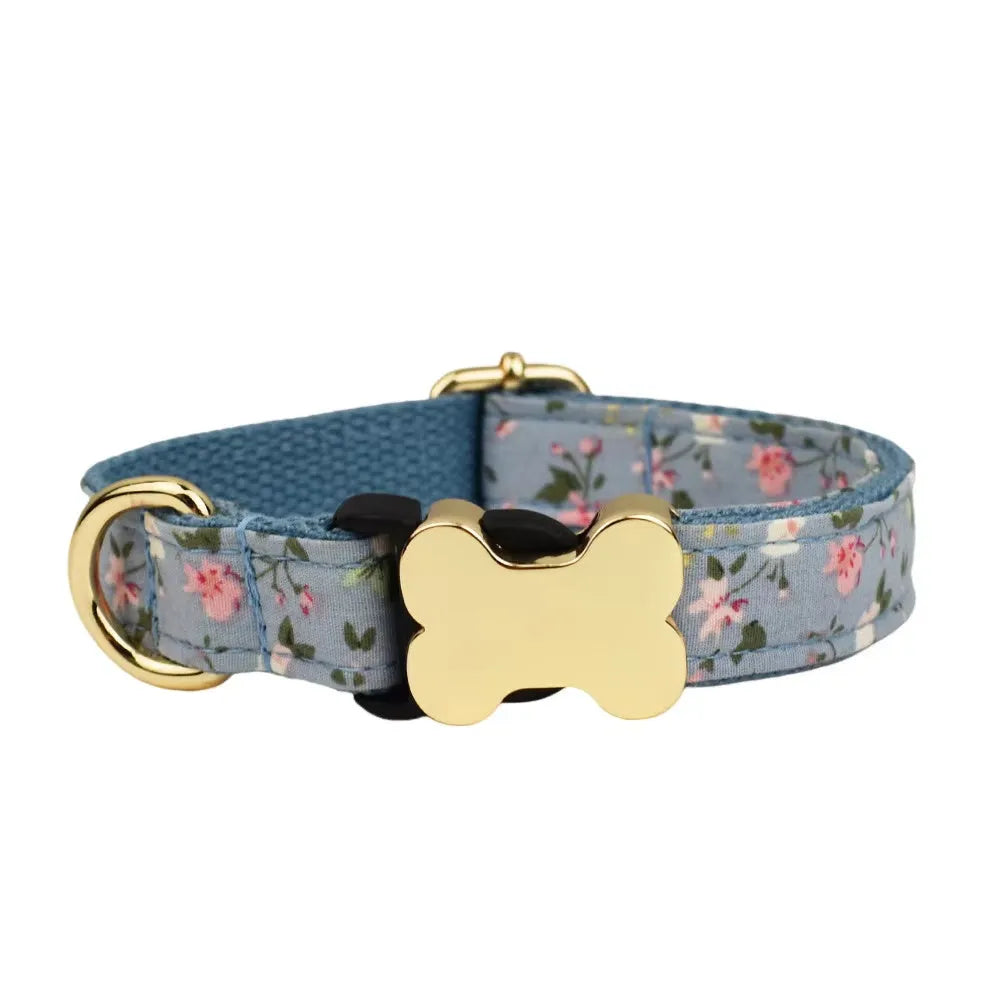 Flat nylon dog collar with printed grid pattern and white bone-shaped plastic buckle on a blue background.