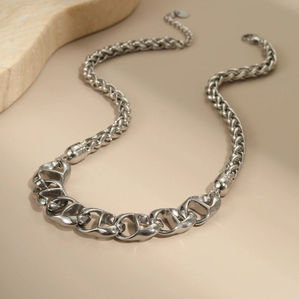 Gold and steel stainless steel geometric pendant necklace with regular chain.