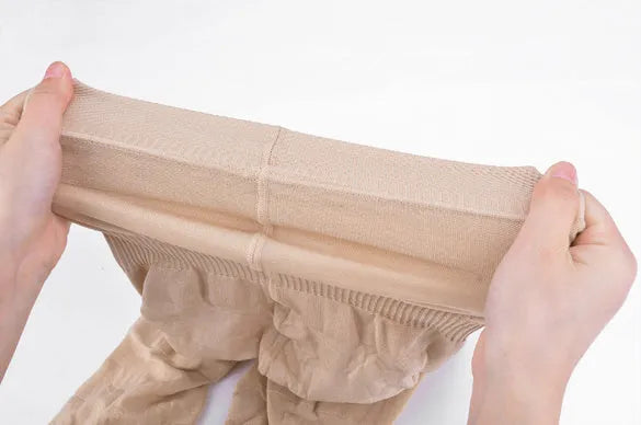 Black high-waist seamless shapewear shorts laid flat showing the waistband and short length.