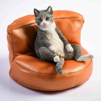 Lazy cat car ornament figure on fabric sofa, 7.5cm high resin model decoration.
