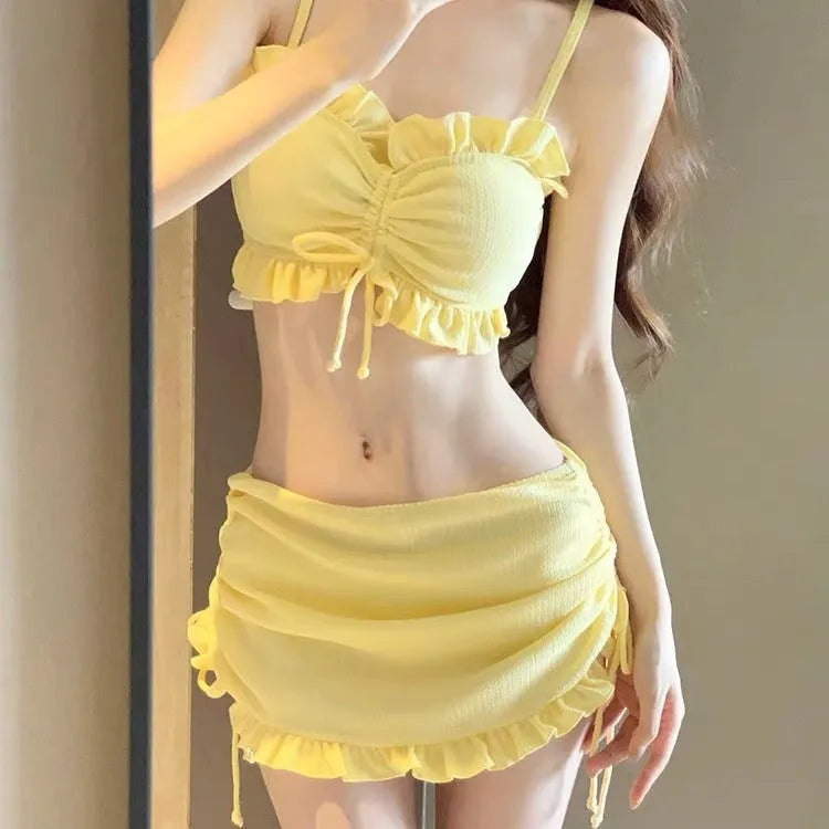 Women's solid colour milk silk bikini swimsuit shown in pitaya red, yellow, and black.