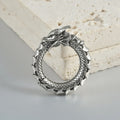 Retro geometric dragon silhouette earrings in antique silver, showing hollow-out design and large size.