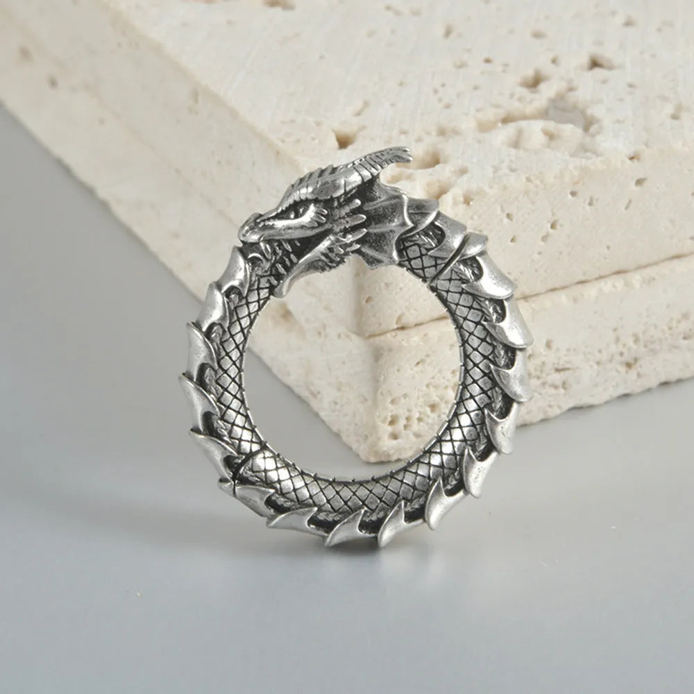 Retro geometric dragon silhouette earrings in antique silver, showing hollow-out design and large size.