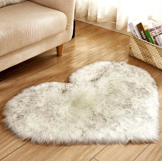 Heart-shaped plush carpet in multiple colours showing wool-like texture with 5-6 cm pile length