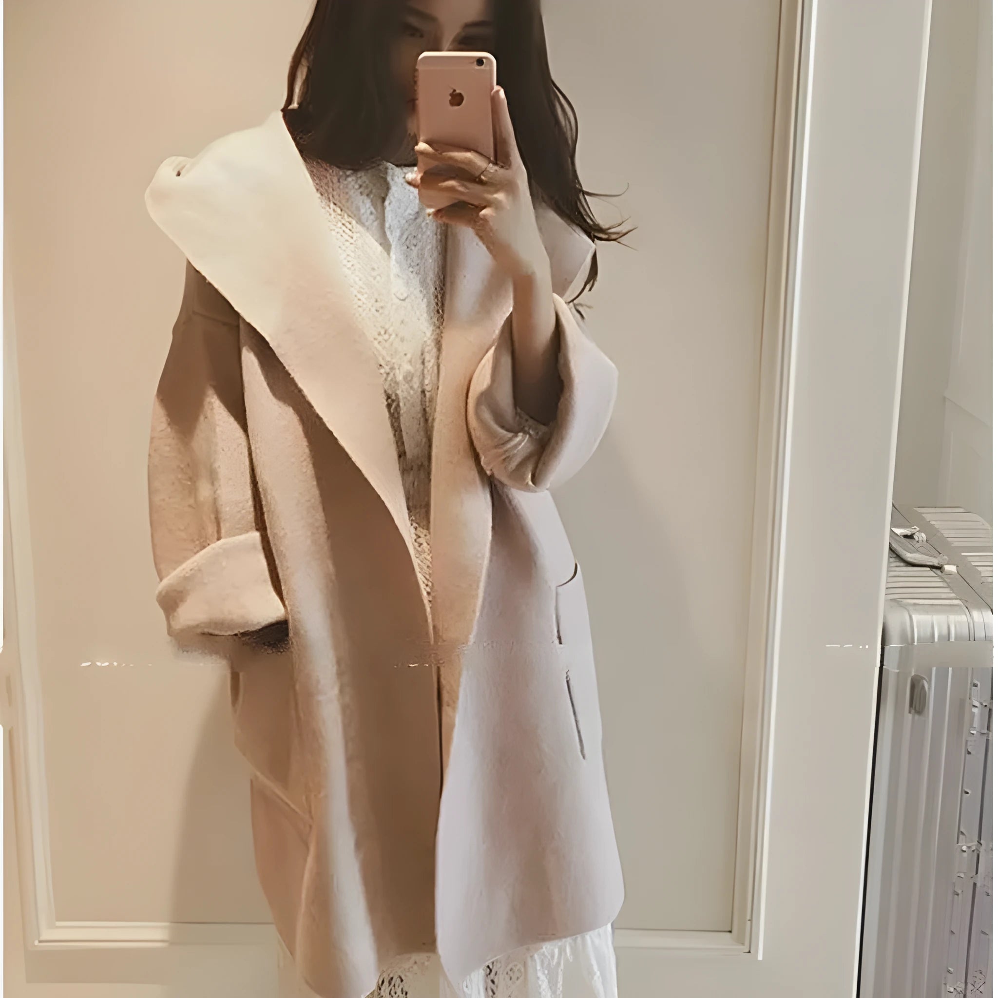 Plus size woman wearing a grey loose-fit cotton coat with lace detailing and long sleeves.