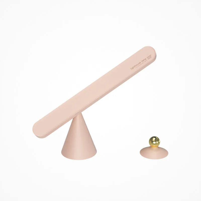 White geometric desk lamp with magnetic base mounted on a metal wall surface.