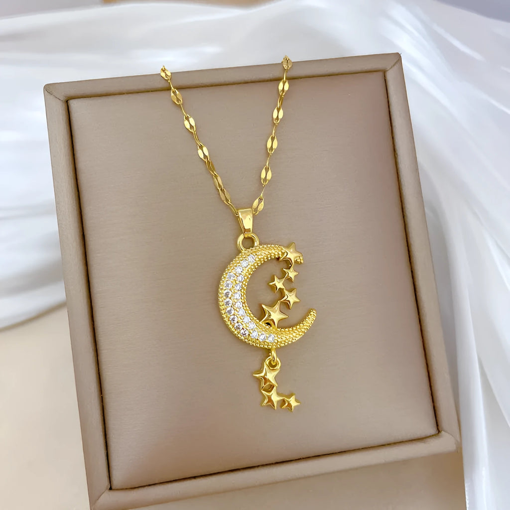 Geometric moon pendant necklace with crystals and tassel detail on an adjustable stainless steel chain.